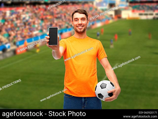 male football fan with smartphone and soccer ball