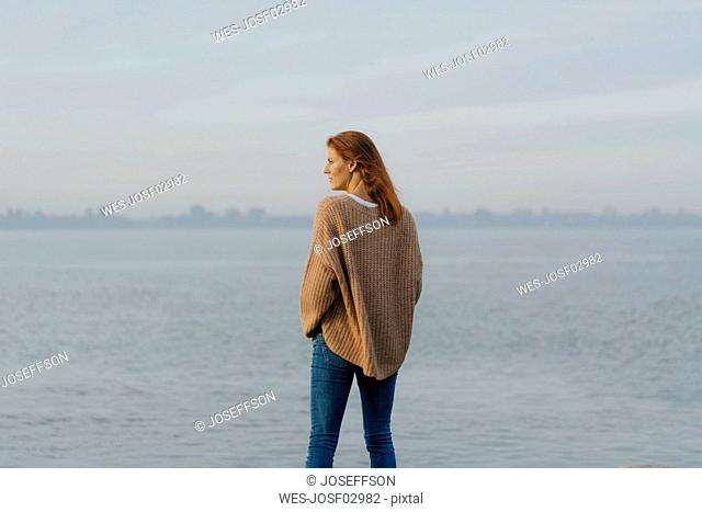 Germany, Hamburg, woman standing at the Elbe shore