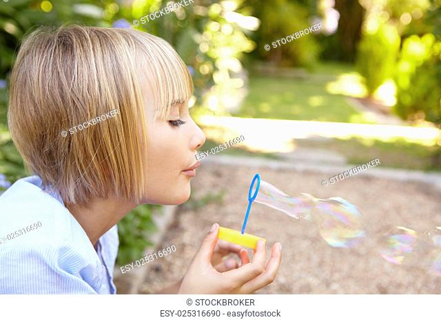 Young girl blowing bubbles