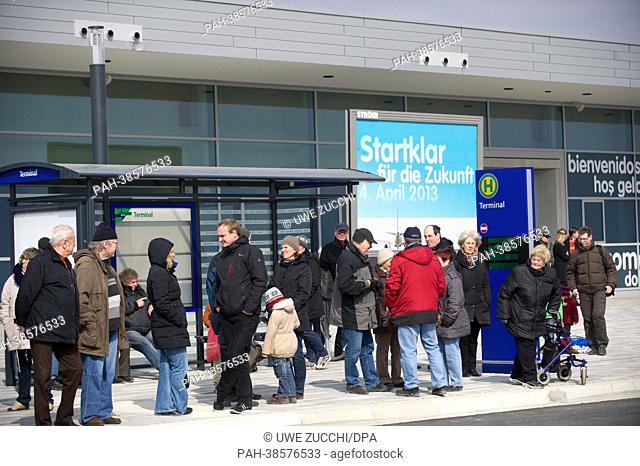 Passengers stand in the terminal at the airport in Kassel-Calden, Germany, 04 April 2013. After around 15 years of planning, testing and construction