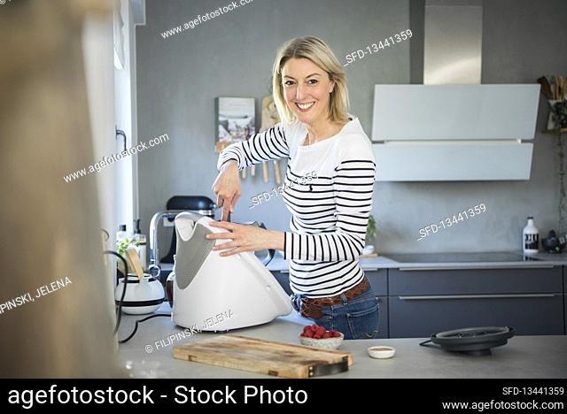 Blonde woman at work in the kitchen