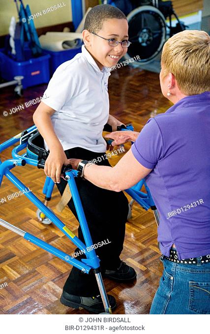 Boy with cerebral palsy using walking aid