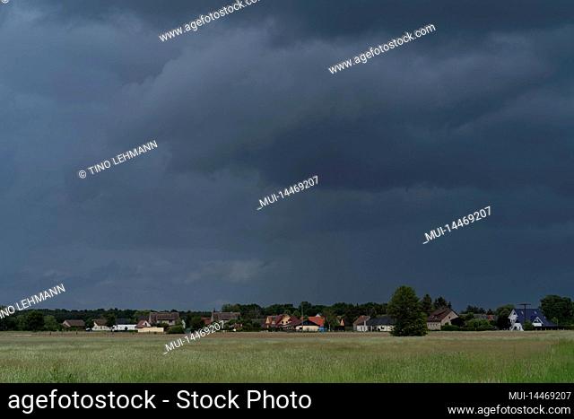 Dark rain clouds just before a storm over a small village near the town of Luckenwalde in Germany