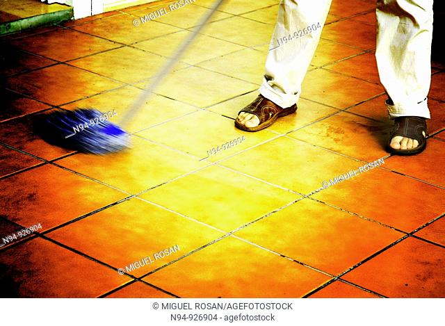 Man mopping the floor of the terrace
