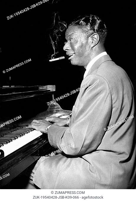 Apr. 28, 1954 - Paris, France - The famous American Crooner and Pianist, NAT KING COLE, trying out his piano before appearing at the Palais De Chaillot Theatre...
