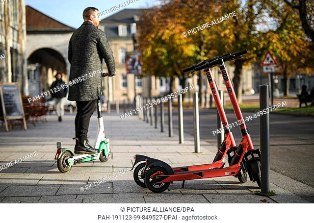 22 November 2019, Baden-Wuerttemberg, Stuttgart: A young man is driving through downtown Stuttgart on an e-scooter. Operators of e-scooters have also taken up...