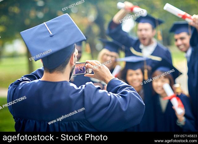 graduate students taking photo with smartphone