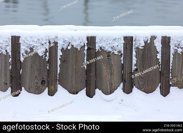 Abstract image of a wooden flood control barrier with snow in Steveston British Columbia Canada