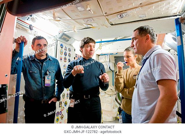 NASA astronaut Michael Barratt (second left), STS-133 mission specialist; Russian cosmonaut Alexander Skvortsov (right), Expedition 23 flight engineer and...