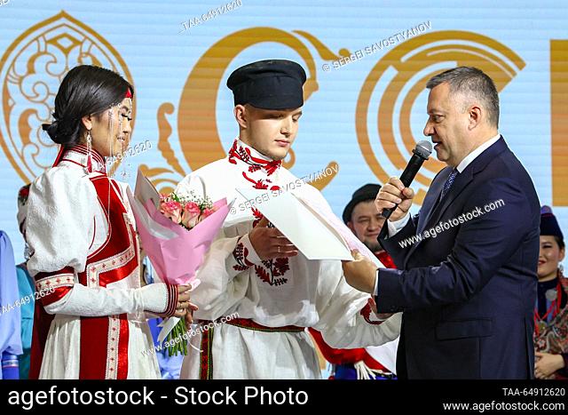 RUSSIA, MOSCOW - NOVEMBER 17, 2023: Irkutsk Region Governor Igor Kobzev (R) is seen with bride Yelena Tumurova and groom Mark Prasolov during a wedding ceremony...
