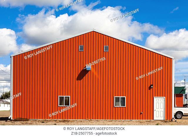 Orange agricultural building in the town of Castor, Alberta, Canada