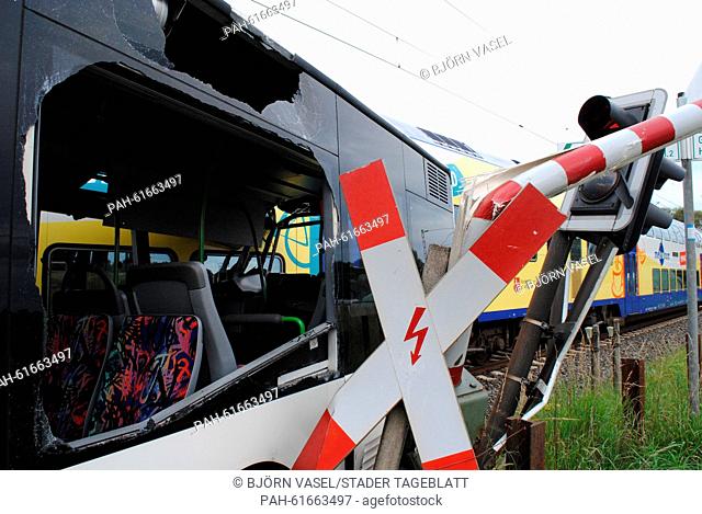 A demolished school bus pictured next to a railway crossing where the unmoving bus collided with a train in Helendorf, Germany, 16 September 2015