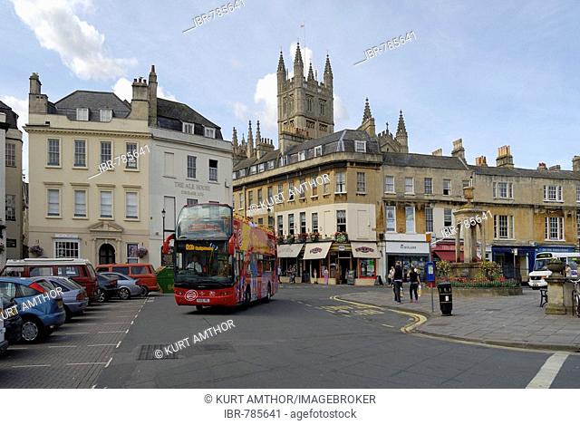 Open-top double decker sightseeing bus in front of Bath Abbey, Bath, Wessex, England, UK