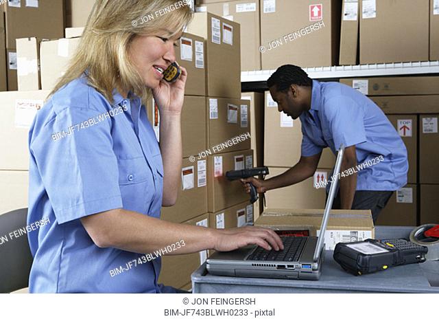 Male and female warehouse workers in warehouse