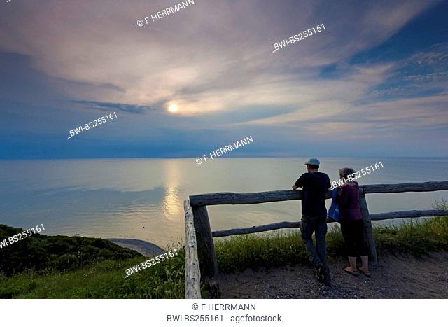 older couple watching the sunset from a viewpoint over the sea, Germany, Mecklenburg-Western Pomerania, Hiddensee
