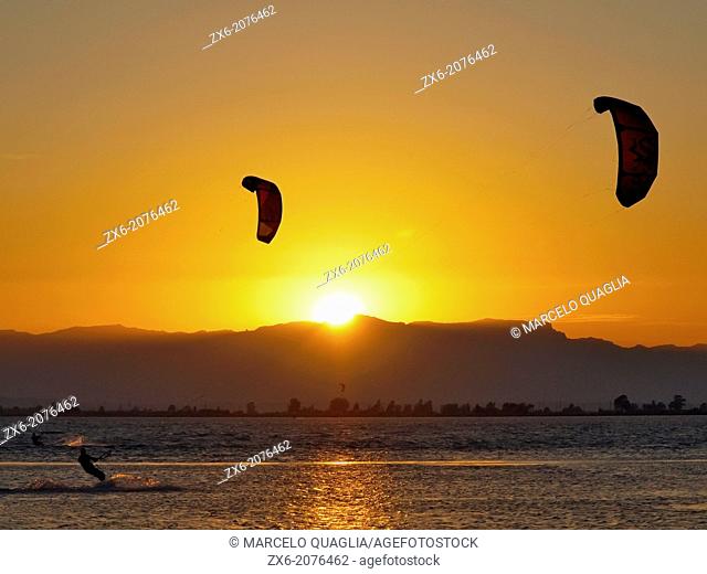 Sunset kitesurfing at Alfacs Bay. Ebro River Delta Natural Park, Tarragona province, Catalonia, Spain