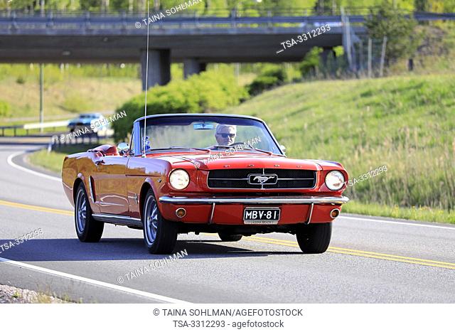 Salo, Finland. May 18, 2019. Classic 1960s red Ford Mustang convertible on the road on Salon Maisema Cruising 2019. Credit: Taina Sohlman/agefotostock
