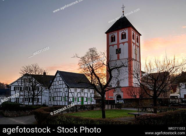 Center of village Odenthal with parish church and old buildings at sunrise, Bergisches Land, Germany
