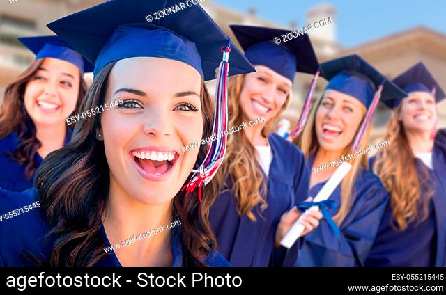 Happy Graduating Group of Girls In Cap and Gown Celebrating on Campus