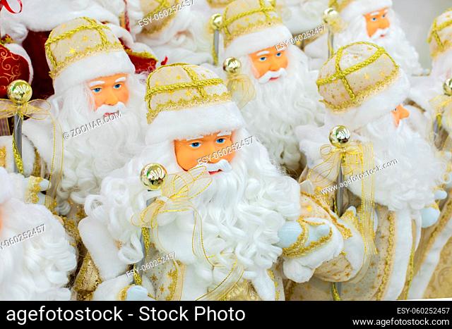many christmas dolls, santa claus in white gold, background backdrop design. Interior decoration, symbol of christmas santa claus with a long white beard