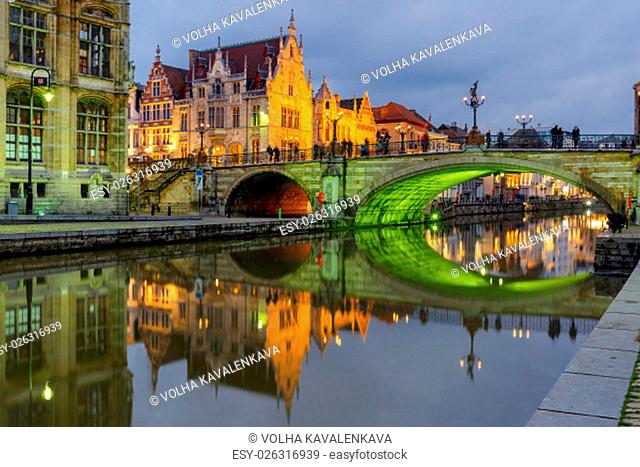 Picturesque medieval building and St. Michael&#39;s Bridge with an unusual green illumination in the evening in Ghent, Belgium
