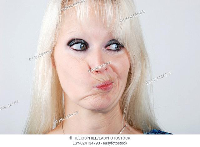 Young blond woman making a face