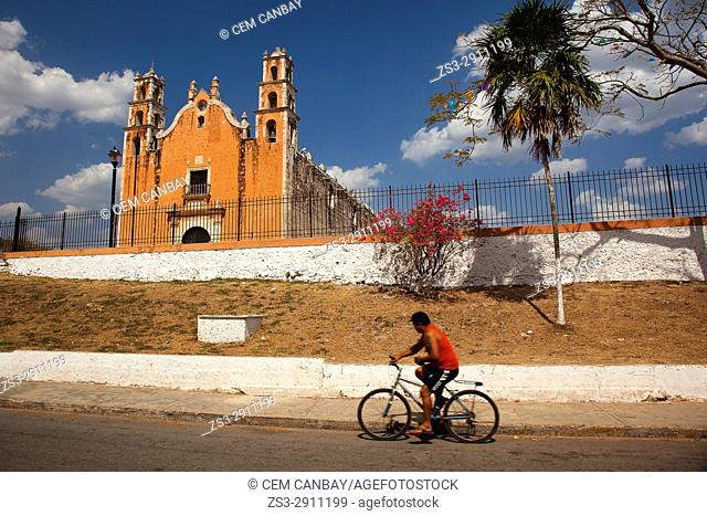 Cyclist in front of the church at the town center, Tecoh, Convent Route, Yucatan Province, Mexico, Central America