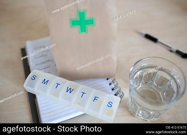 Prescription bag and pill box with glass of water
