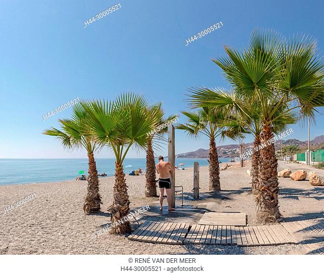 El Playazo beach with palm trees and a shower, Nerja, Spain