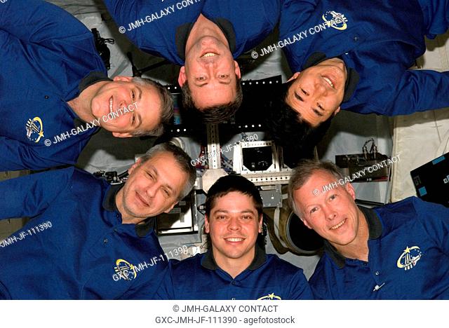 The STS-123 crew used part of its last full day onboard the International Space Station posing for some in-space crew portraits