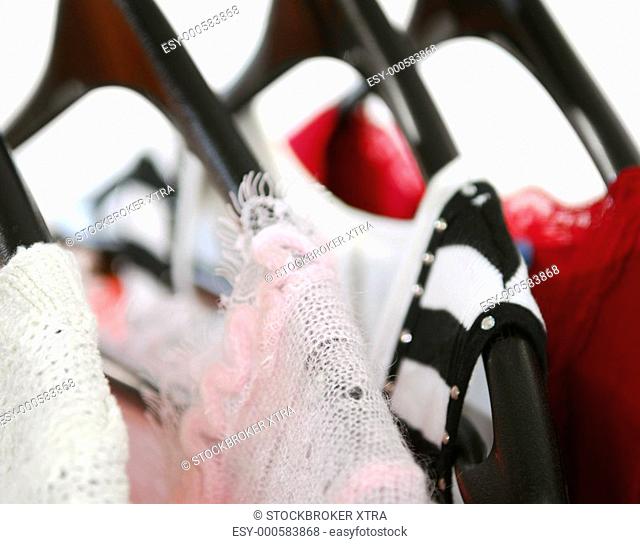 Women's clothing on a rack on black hangers