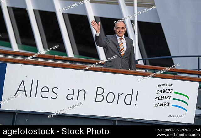 02 September 2020, Saxony, Dresden: Robert Straubhaar, managing director of United Rivers AG from Basel, waves from a pier of the salon ship ""August der...