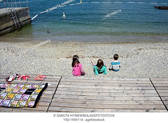 children resting at the beach, Lake Geneva shore, Paquis plage, Paquis beach, Lac Leman, Geneva, Switzerland