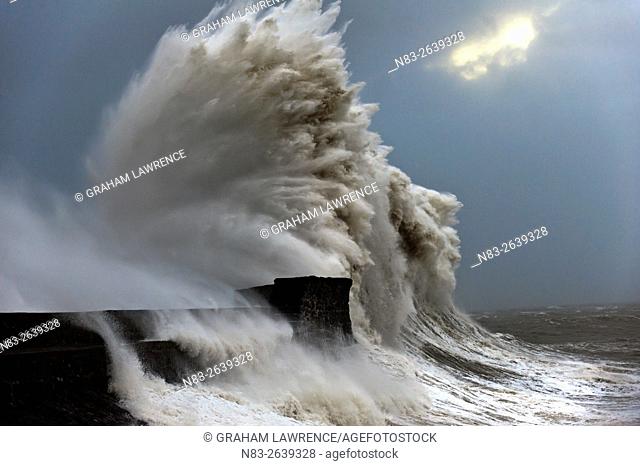 Huge waves crash against the harbour wall at Porthcawl, Bridgend, Wales, UK