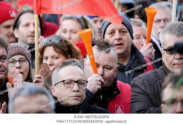 Siemens employees protesting against planned lay-offs carrying signs, whistles and horns during a meeting of the IG Metall metalworkers' union's Siemens chapter...