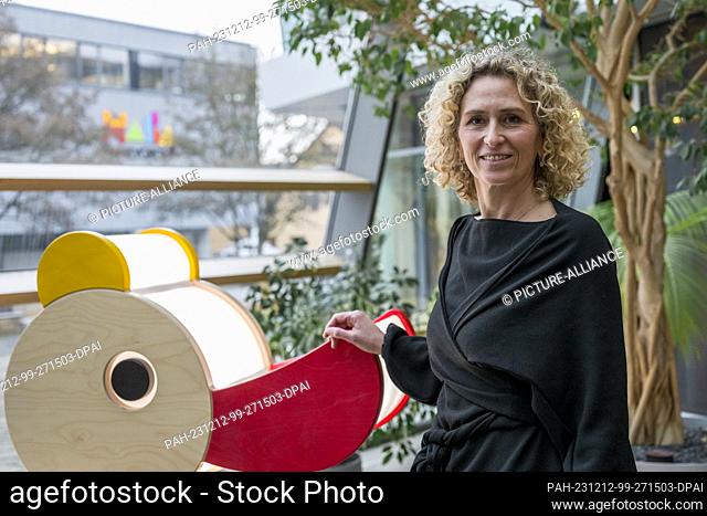 12 December 2023, Bavaria, Bad Rodach: Stefanie Frieß, HABA Sales & Marketing Director, in the foyer next to a wooden duck. Photo: Daniel Vogl/dpa