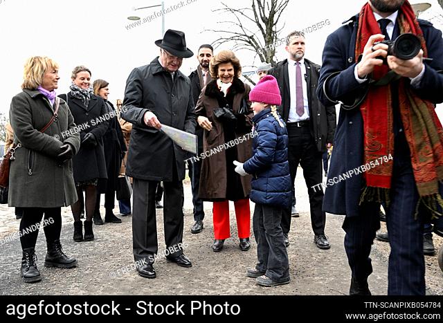 Sweden's King Carl XVI Gustaf and Queen Silvia receive a map from a young admirer while walking to Stora torget in Nykoping during the royal visit to...