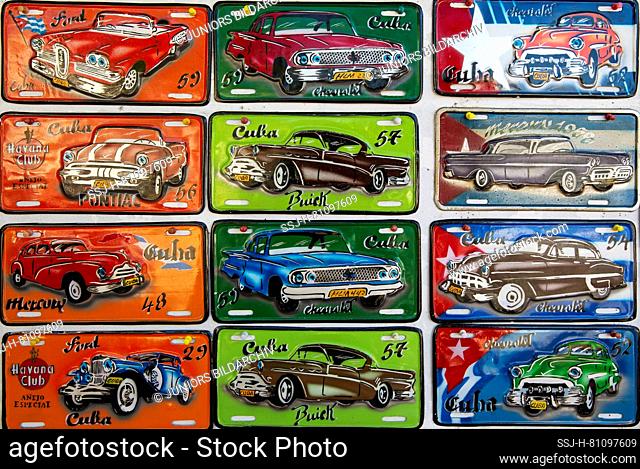 Retro style tin plaques of US classic cars at a souvenir stall, Cienfuegos, Cuba