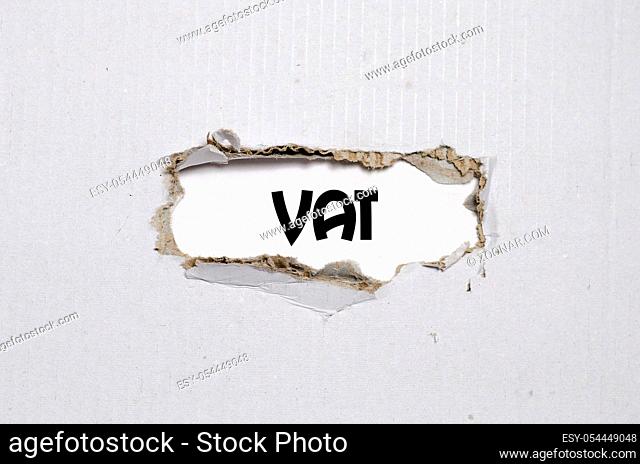 The word vat appearing behind torn paper