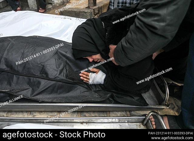 14 December 2023, Palestinian Territories, Rafah: Palestinians bid farewell to their relatives who were killed during an Israeli bombardment
