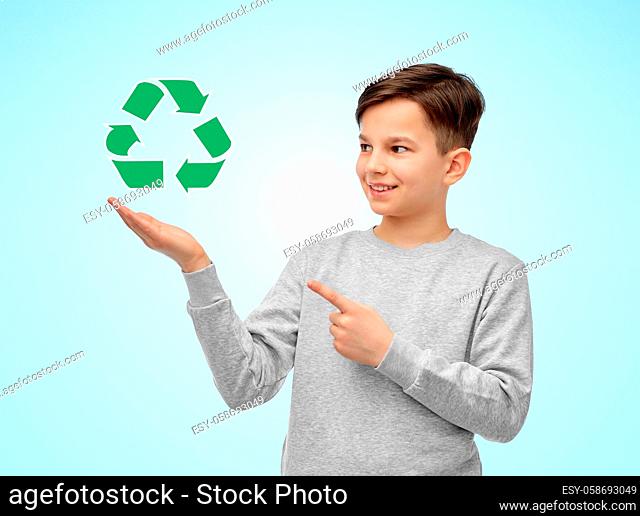 smiling boy showing green recycling sign