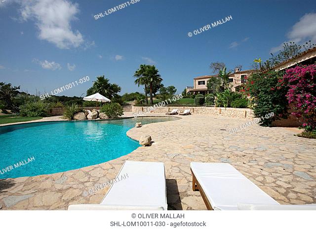 Outdoor swimming pool and stone patio