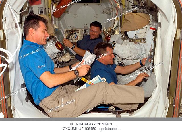 Astronauts Paolo Nespoli (foreground) representing the European Space Agency (ESA), Scott Parazynski (right) and Doug Wheelock, all STS-120 mission specialists
