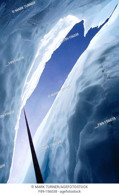 Climbing rope descends into crevasse in Easton Glacier. Mount Baker Wilderness. Washington. USA