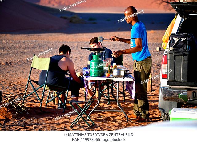 Tourists will be served breakfast by local guides after the ascent at the foot of the dunes, taken on 01.03.2019. The Sossusvlei in the Namib-Naukluft National...