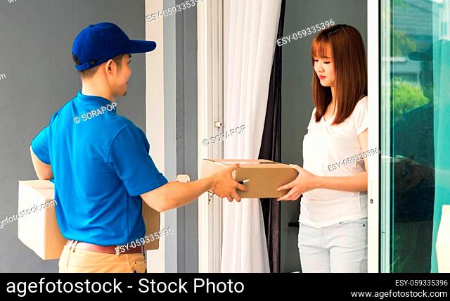 Asian beautiful customer young woman signing delivery in clipboard get her package from service courier man, smiling female signature receipt of delivery...