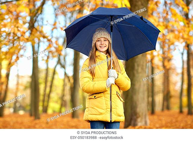 happy girl with umbrella at autumn park