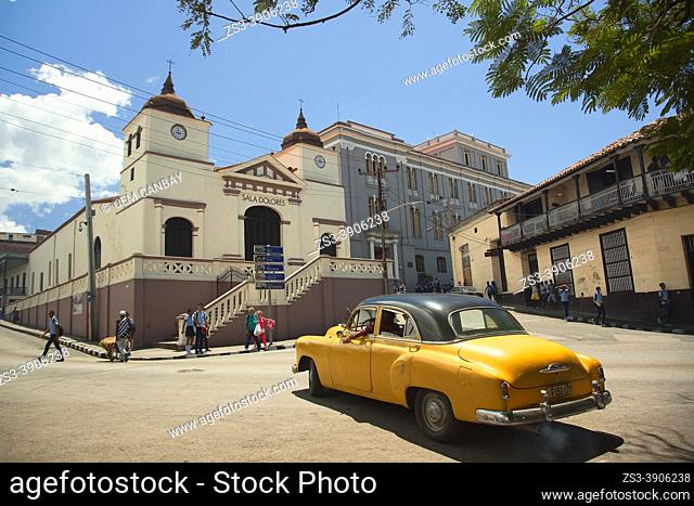 Old American car in front of the Dolores Hall-Sala Dolores at Plaza Dolores Square in the historic center, Santiago De Cuba, Cuba, West Indies, Central America