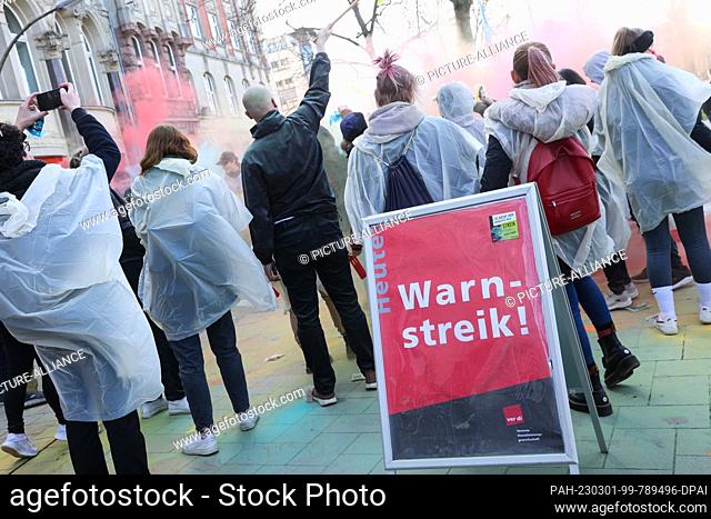 01 March 2023, Hamburg: Participants of a nationwide youth strike day of trainees and dual students in the public sector demonstrate with colorful Holi colors...