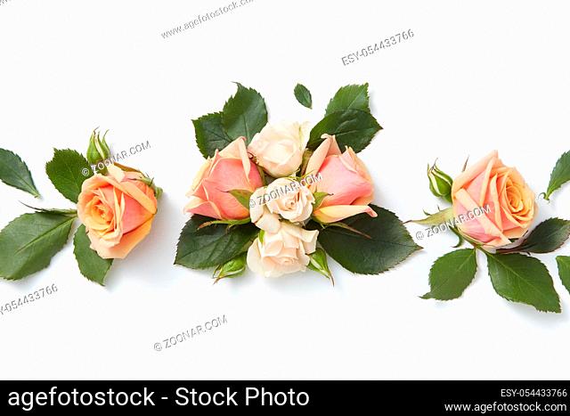 Romantic composition from beautiful roses flowers on a light grey background with copy space. Flat lay. Greeting card for Valentine's Day